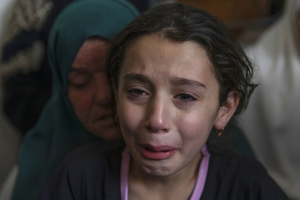 Palestinian Batoul Shamsa, 10, cries during the funeral of her brother Ahmad Shamsa, 15, in the West Bank village of Beta, near Nablus, Thursday, June. 17, 2021. The Palestinian health ministry said Thursday that Shamsa who was shot by Israeli troops in the West Bank a day earlier died of his injuries. (AP Photo/Nasser Nasser)