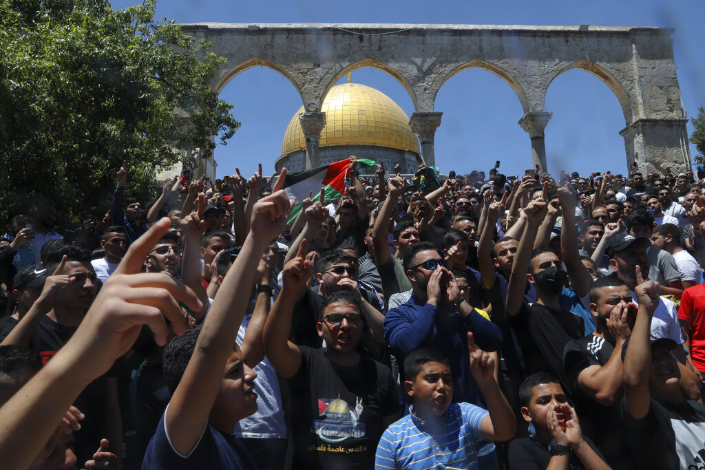 Palestinians chant slogans during a protest in front of the Dome of the Rock Mosque at the Al Aqsa Mosque compound in Jerusalem's Old City, Friday, June 18, 2021. Hundreds demonstrated after Friday prayers in response to a rally held by Jewish ultranationalists on Tuesday in which dozens had chanted 