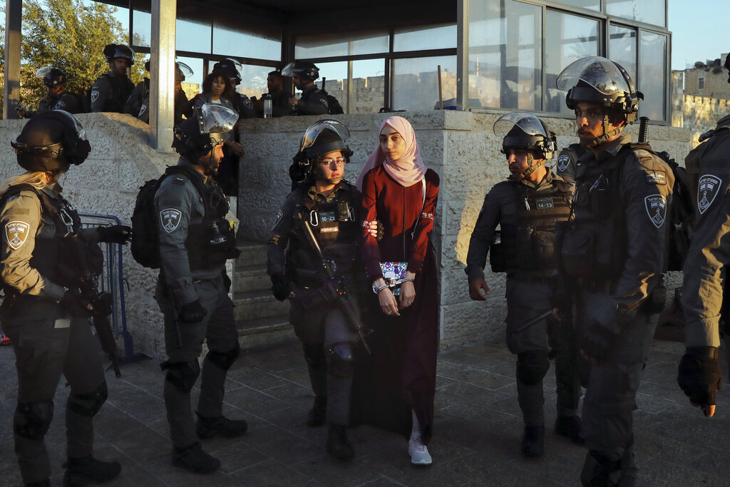 Israeli border police detain a Palestinian woman during protest in Damascus gate just outside Jerusalem's Old City, Saturday, June 19, 2021. Tens of Palestinians demonstrated in response to a rally held by Jewish ultranationalists on Tuesday in which dozens had chanted 