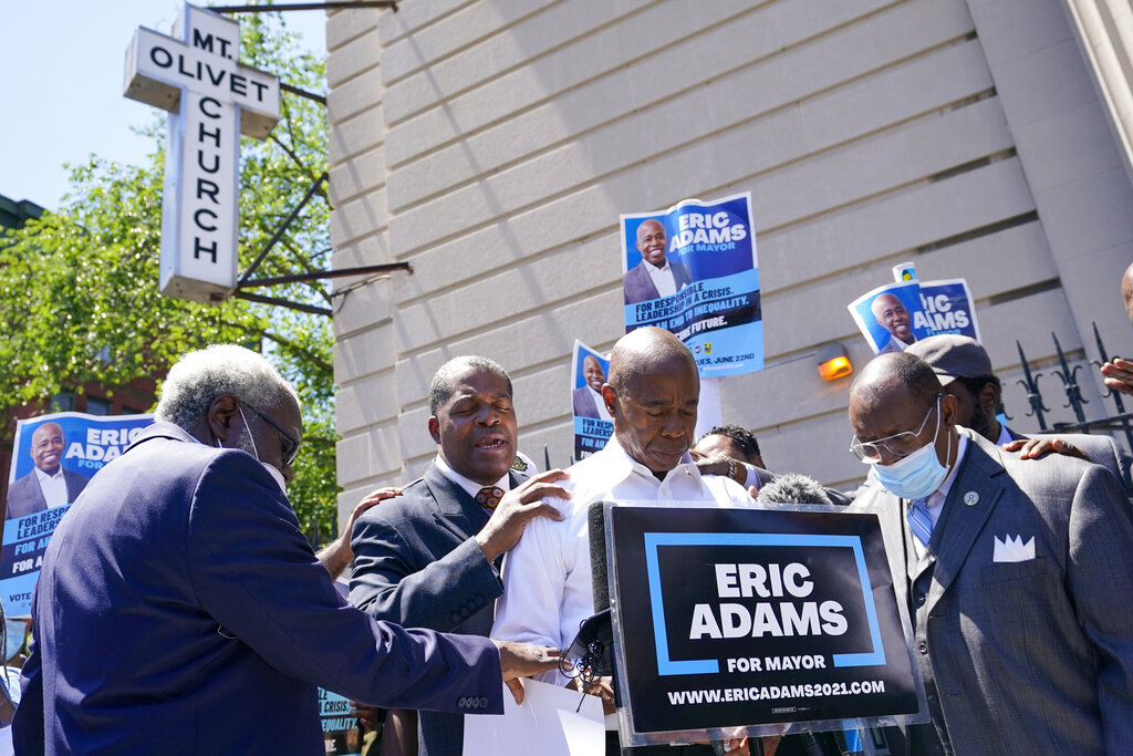 Clergy members pray with Democratic mayoral candidate Eric Adams at the start of a a campaign event, Thursday, June 17, 2021, in the Harlem neighborhood of New York. (AP Photo/Mary Altaffer)