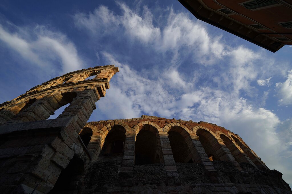 An external view of the Arena di Verona theatre, in Verona, Italy, Friday, June 25, 2021. The Verona Arena amphitheater returns to staging full operas for the first time since the pandemic struck but with one big difference. Gone are the monumental sets that project the scene to even nosebleed seats in the Roman-era amphitheater, replaced by huge LED screens with dynamic, 3D sets that are bringing new technological experiences to the opera world. (AP Photo/Luca Bruno)