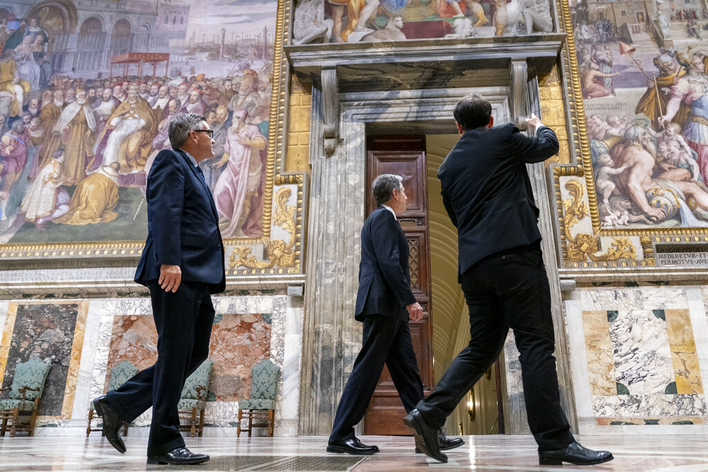 Secretary of State Antony Blinken, center, accompanied by tour guide Alessandro Conforti, right, and Chargé d'Affaires of the U.S. Embassy to the Holy See Patrick Connell, left, gets a tour of the Sala Regia at the Vatican in Rome, Monday, June 28, 2021. Blinken is on a week long trip in Europe traveling to Germany, France and Italy. (AP Photo/Andrew Harnik, Pool)