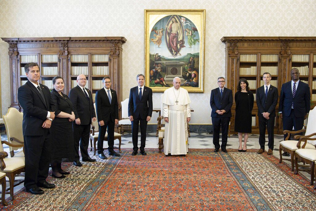 Pope Francis poses with Secretary of State Antony Blinken and members of his delegation, as they meet at the Vatican, Monday, June 28, 2021. Blinken is on a week long trip in Europe traveling to Germany, France and Italy. (Vatican Media via AP Photo)