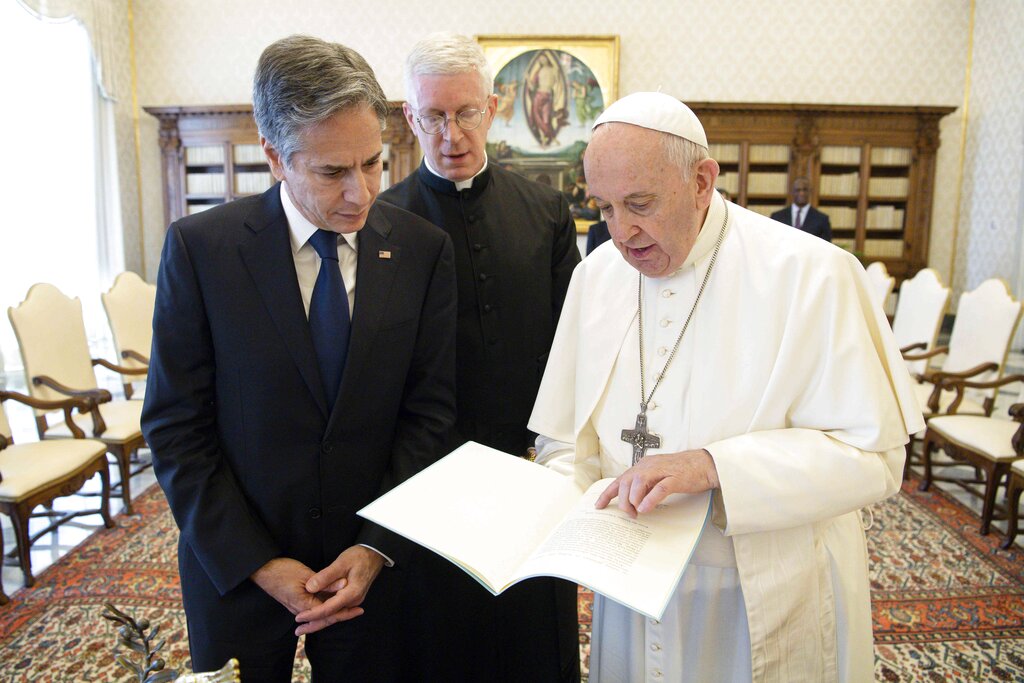 Pope Francis exchange gifts with Secretary of State Antony Blinken, as they meet at the Vatican, Monday, June 28, 2021. Blinken is on a week long trip in Europe traveling to Germany, France and Italy. (Vatican Media via AP Photo)