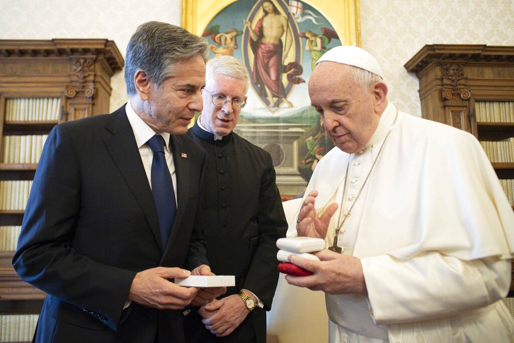 Pope Francis exchange gifts with Secretary of State Antony Blinken, as they meet at the Vatican, Monday, June 28, 2021. Blinken is on a week long trip in Europe traveling to Germany, France and Italy. (Vatican Media via AP Photo)
