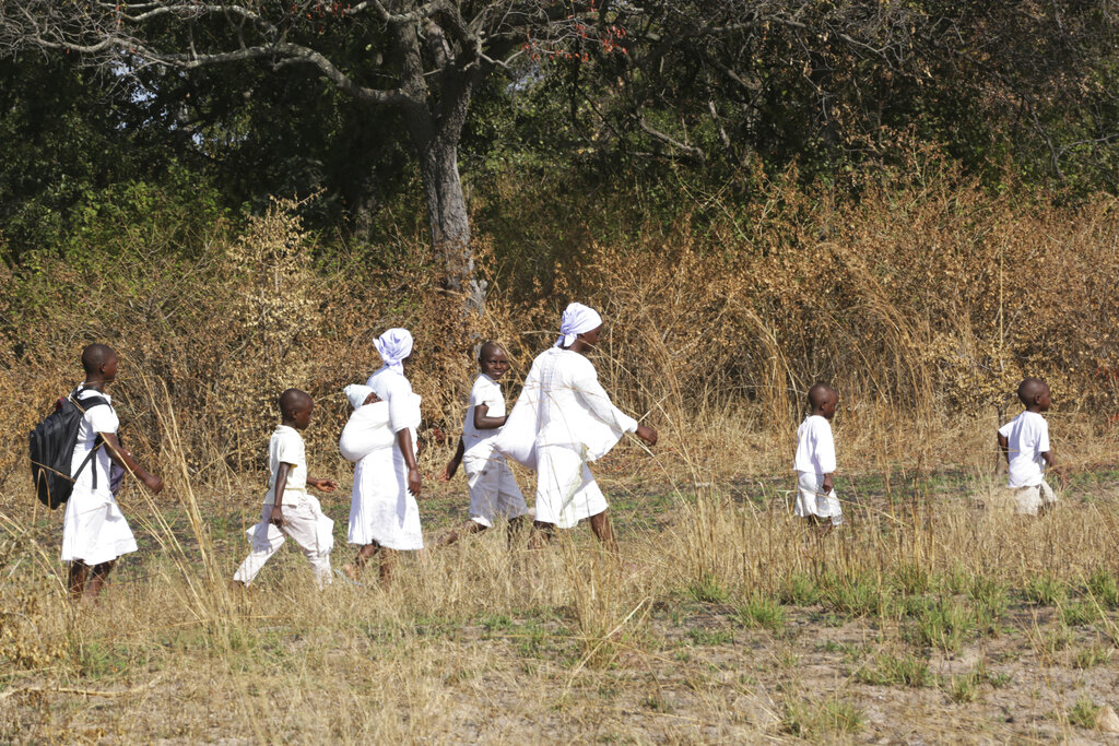A family, belonging to the Apostolic sect go to church in Zvimba in rural Zimbabwe on Friday, June, 25, 2021. A new surge of the coronavirus is finally penetrating Africa’s rural areas, where most people on the continent live, spreading to areas that once had been seen as safe havens from infections that hit cities particularly hard. (AP Photo/Tsvangirayi Mukwazhi)
