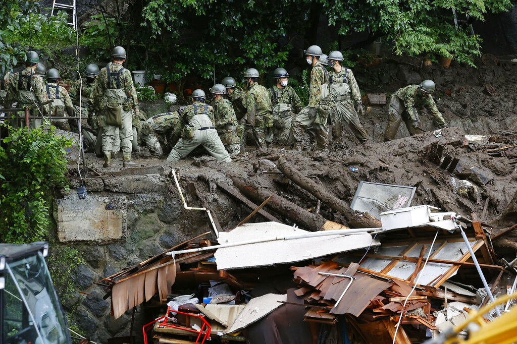 Rescuers continue a search operation at the site of a mudslide at Izusan in Atami, Shizuoka prefecture, southwest of Tokyo Monday, July 5, 2021. (Kyodo News via AP)