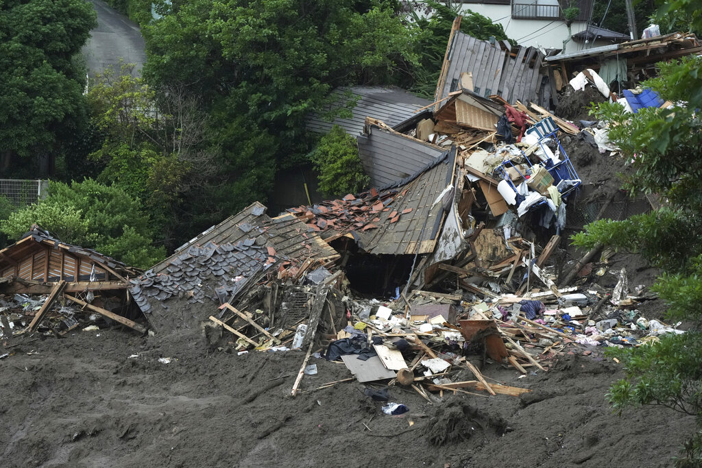 Damaged houses and infrastructures are seen at a mudslide area caused by heavy rains in Atami, Shizuoka Prefecture, west of Tokyo, Monday, July 5, 2021. Rescue workers are slogging through mud and debris looking for dozens unaccounted for after a giant landslide ripped through the Japanese seaside resort town. (AP Photo/Eugene Hoshiko)