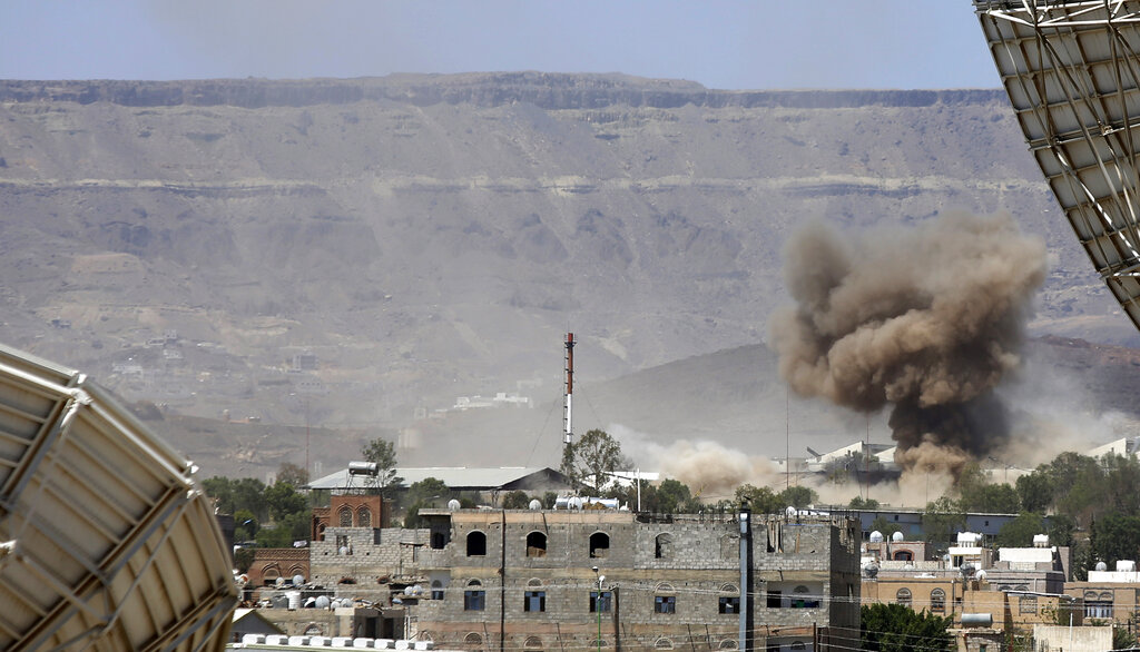 FILE - In this Sept. 9, 2015 file photo, smoke rises after an airstrike by the Saudi-led coalition on an army base in Sanaa, Yemen.  Yemen’s war began in September 2014, when the Houthis seized the capital Sanaa. Saudi Arabia, along with the United Arab Emirates and other countries, entered the war alongside Yemen’s internationally recognized government in March 2015. The war has killed some 130,000 people and driven the Arab world’s poorest country to the brink of famine. (AP Photo/Hani Mohammed)