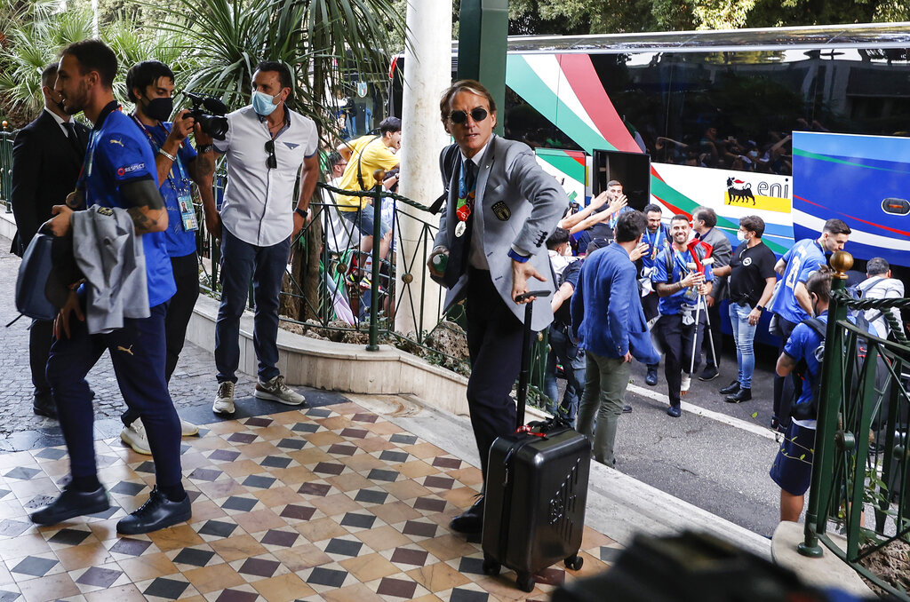 Italy's head coach Roberto Mancini and his team arrive at a hotel after returning from London, in Rome, Monday, July 12, 2021. Italy defeated England 3-2 in a penalty shootout after a 1-1 draw, to win the Euro 2020 soccer championships in a final played at Wembley stadium in London on July 11. (AP Photo/Riccardo De Luca)