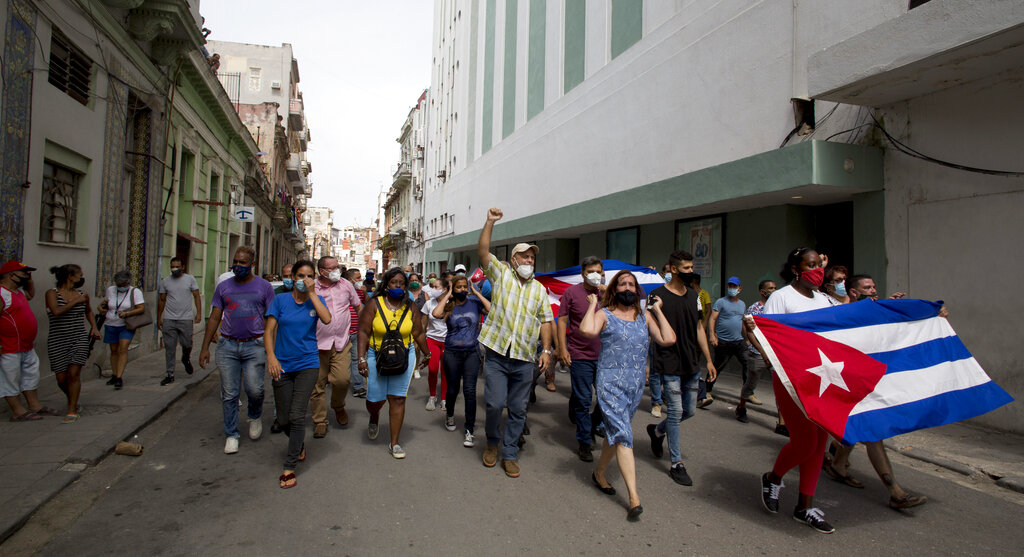 Backers of the government march in Havana, Cuba, Sunday, July 11, 2021. Hundreds of supporters of the government took to the streets while hundreds  protested against ongoing food shortages and high prices of foodstuffs. (AP Photo/Ismael Francisco)