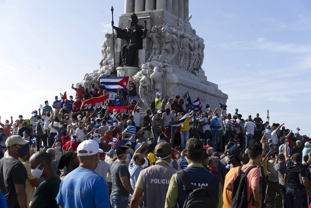 CORRECTS TO GOVERNMENT SUPPORTERS - Government supporters gather at the Maximo Gomez monument in Havana, Cuba, Sunday, July 11, 2021. Supporters of the government took to the streets at the time hundreds more protested against ongoing food shortages and high prices of foodstuffs.. (AP Photo/Eliana Aponte)