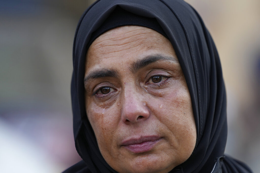 Ilham al-Bikai, mother of Ahmad Kaadan, who died during the Aug. 4, 2020, Beirut port explosion, cries during a protest near the parliament building to demand an expedited investigation, in Beirut, Lebanon, Sunday, July 4, 2021. A year after the deadly blast, families of the victims are consumed with winning justice for their loved ones and punishing Lebanon's political elite, blamed for causing the disaster through their corruption and neglect. Critics say the political leadership has succeeded so far in stonewalling the judicial investigation into the explosion. (AP Photo/Hassan Ammar)