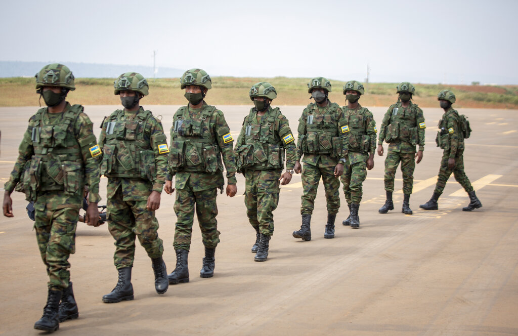 Rwandan armed forces prepare to board a flight to Mozambique, at the airport in Kigali, Rwanda Saturday, July 10, 2021. Rwanda on Friday said it would immediately deploy 1,000 members of its armed forces and police to northern Mozambique to help battle an Islamic extremist insurgency. (AP Photo/Muhizi Olivier)