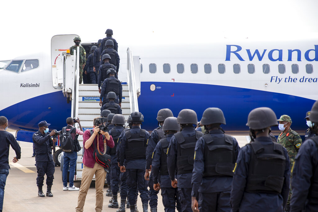 Rwandan police prepare to board a flight to Mozambique, at the airport in Kigali, Rwanda Saturday, July 10, 2021. Rwanda on Friday said it would immediately deploy 1,000 members of its armed forces and police to northern Mozambique to help battle an Islamic extremist insurgency. (AP Photo/Muhizi Olivier)