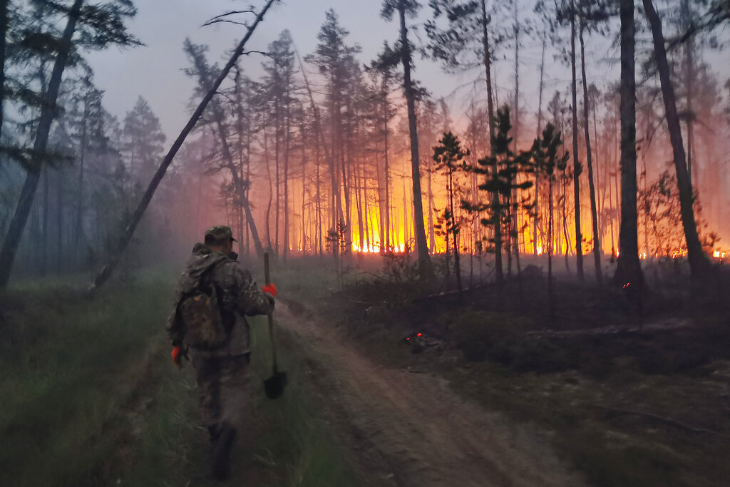 A volunteer heads to douse a forest fire in the republic of Sakha also known as Yakutia, Russia Far East, Saturday, July 17, 2021. Russia has been plagued by widespread forest fires, blamed on unusually high temperatures and the neglect of fire safety rules, with the Sakha-Yakutia region in northeastern Siberia being the worst affected. (AP Photo/Ivan Nikiforov)
