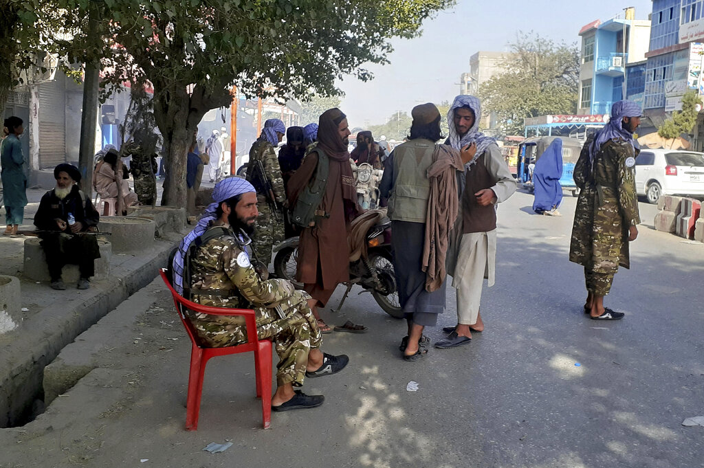 Taliban fighters stand guard at a checkpoint in Kunduz city, northern Afghanistan, Monday, Aug. 9, 2021. The militants have ramped up their push across much of Afghanistan in recent weeks, turning their guns on provincial capitals after taking district after district and large swaths of land in the mostly rural countryside. (AP Photo/Abdullah Sahil)