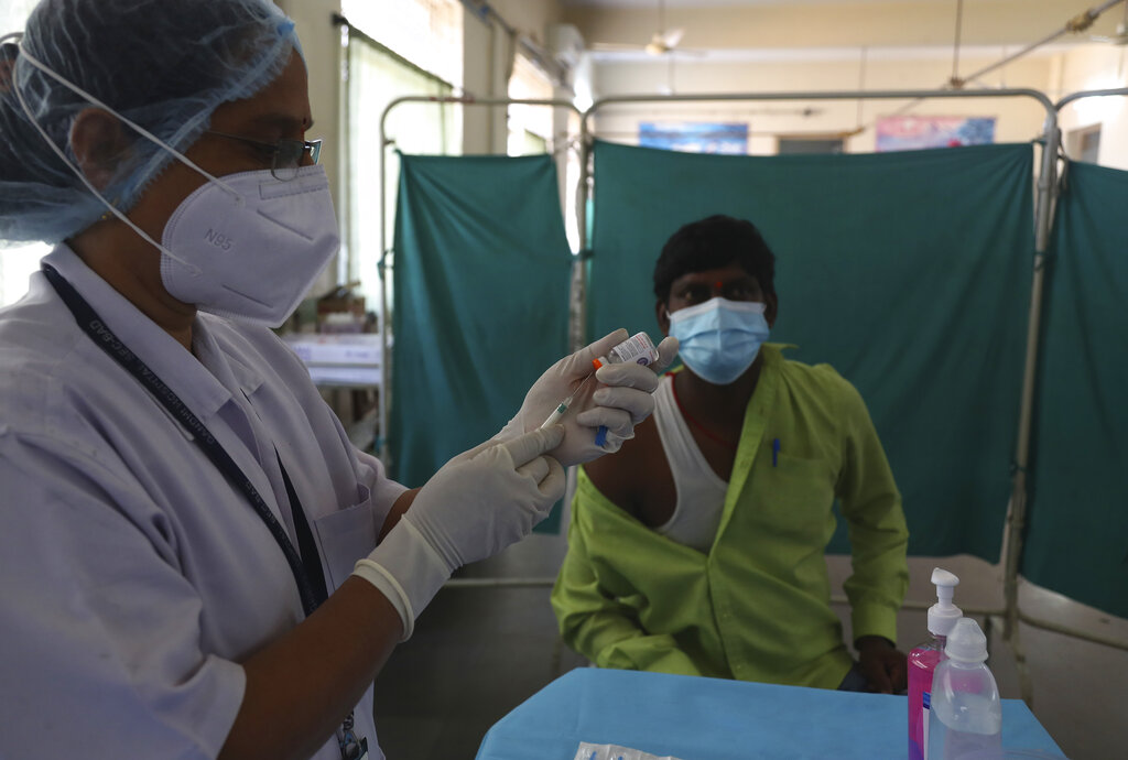 A health worker participates in a COVID-19 vaccine delivery system trial in Hyderabad, India, Saturday, Jan. 2, 2021. India tested its COVID-19 vaccine delivery system with a nationwide trial on Saturday as it prepares to roll-out an inoculation program to stem the coronavirus pandemic. Saturday's exercise included necessary data entry into an online platform for monitoring vaccine delivery, along with testing of cold storage and transportation arrangements for the vaccine, the health ministry had said.(AP Photo/Mahesh Kumar A.)