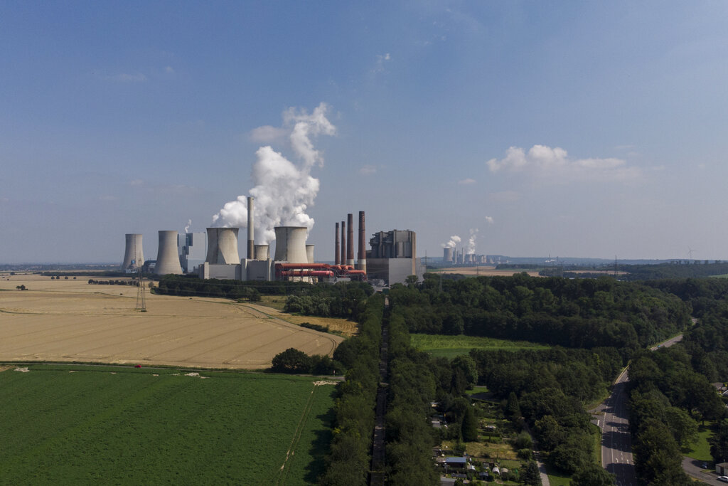 A view of a power plant in the town of Frimmersdorf, Germany, Tuesday, July 20, 2021. Last week's flood disaster has propelled the issue of climate change to the fore of an election campaign that will determine who succeeds Angela Merkel as German chancellor after 16 years in office. (AP Photo/Bram Janssen)