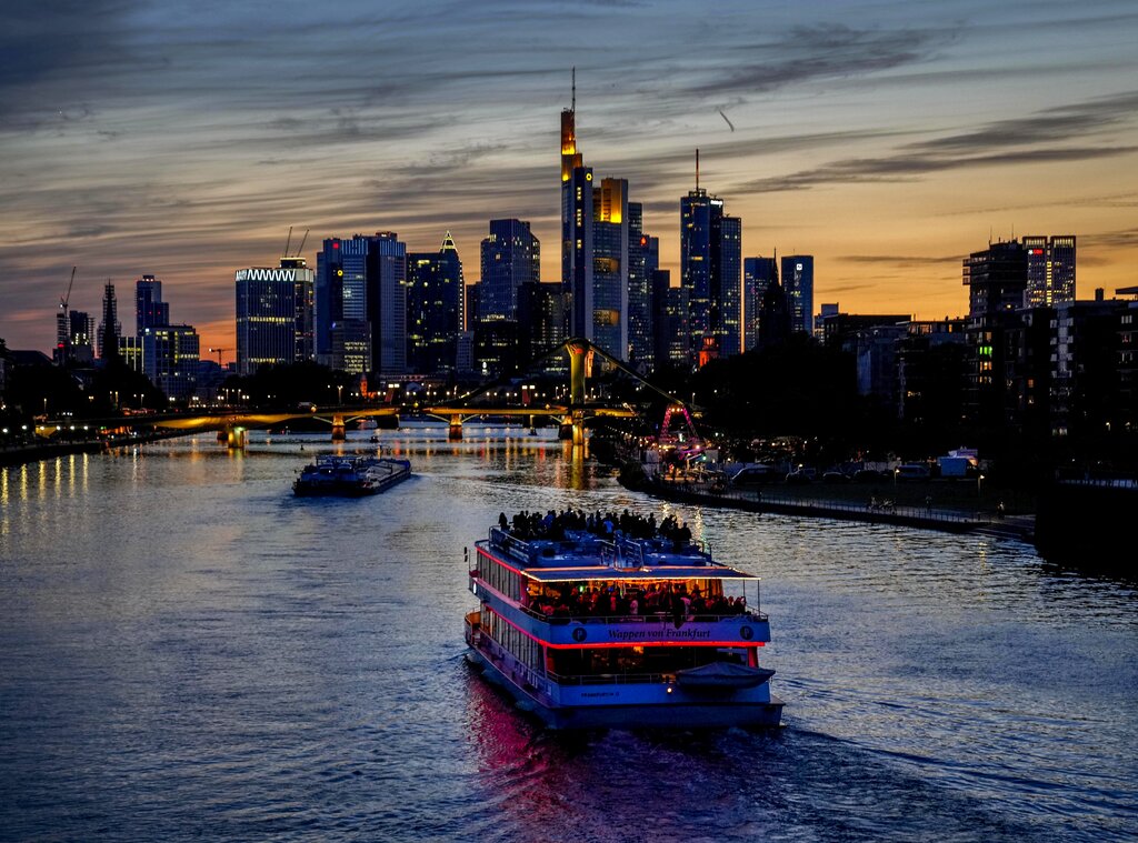 People party on an illuminated boat on the river Main in Frankfurt, Germany, late Friday, Aug. 6, 2021. (AP Photo/Michael Probst)