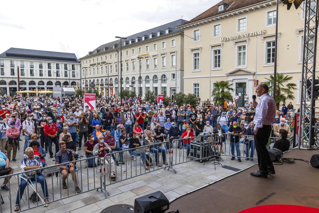 Olaf Scholz, top canditate of the German Social Democrats, speaks to the audience  during an election campaign event on a market square in Karlsruhe, Germany, Monday, Aug. 23, 2021. A large chunk of the German electorate remains undecided going into an election that will determine who succeeds Angela Merkel as chancellor after 16 years in power. Recent surveys show that support for German political parties has flattened out, with none forecast to receive more than a quarter of the vote. (Philipp von Ditfurth/dpa via AP)