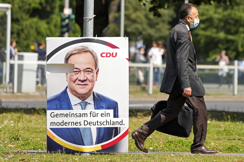 An election poster for the German Christian Democrats, CDU, shows top candidate Armin Laschet at a street in Duesseldorf, Germany, Wednesday, Aug. 25, 2021. A large chunk of the German electorate remains undecided going into an election that will determine who succeeds Angela Merkel as chancellor after 16 years in power. Recent surveys show that support for German political parties has flattened out, with none forecast to receive more than a quarter of the vote. (AP Photo/Martin Meissner)