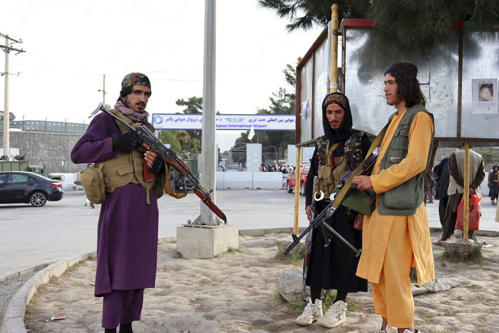 Taliban fighters stand guard in front of the Hamid Karzai International Airport after the U.S. withdrawal in Kabul, Afghanistan, Tuesday, Aug. 31, 2021. The Taliban were in full control of Kabul's international airport on Tuesday, after the last U.S. plane left its runway, marking the end of America's longest war. (AP Photo/Khwaja Tawfiq Sediqi)