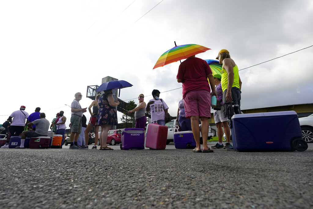 In the aftermath of Hurricane Ida people lining up for food and ice at a distribution center Wednesday, Sept. 1, 2021, in New Orleans, La. (AP Photo/Eric Gay)
