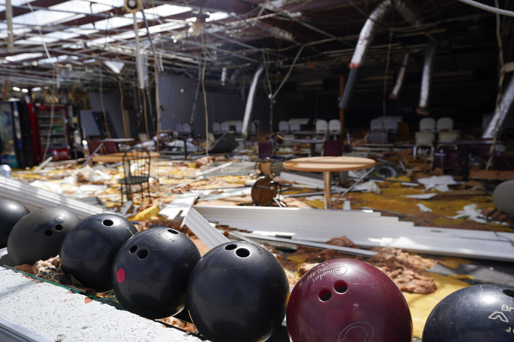 In the aftermath of Hurricane Ida, bowling balls sit in a rack at the heavily damaged Bowl South of Louisiana Tuesday, Aug. 31, 2021, in Houma, La. (AP Photo/David J. Phillip)