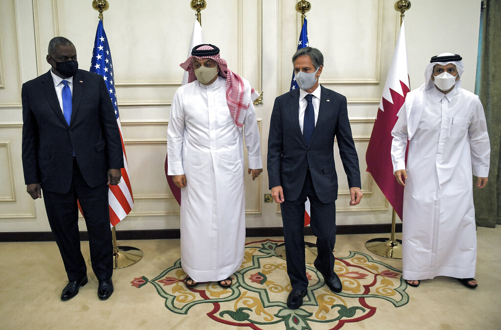 US Secretary of State Antony Blinken, second right and Secretary of Defense Lloyd Austin, left, pose for a photo with Qatari Deputy Prime Minister and Foreign Minister Mohammed bin Abdulrahman Al Thani, right and Qatari Deputy Prime Minister and Defense Minister Dr. Khalid bin Mohammed Al-Attiyah, second left, at the Ministry of Foreign Affairs in Doha, Qatar, Tuesday, Sept. 7, 2021. (Olivier Douliery/Pool Photo via AP)