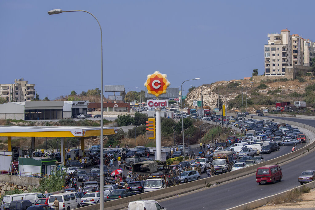 A general view of a petrol station on the main highway that link the Capital Beirut to south Lebanon as cars come from every direction to try and fill their tanks with gasoline, in the coastal town of Jiyeh, south of Beirut, Lebanon, Friday, Sept. 3, 2021.  Lebanon is mired in a devastating economic and financial crisis, the worst in its modern history. A result of this has been crippling power cuts and severe shortages in gasoline and diesel that have been blamed on smuggling, hoarding and the cash-strapped government’s inability to secure deliveries of oil products. (AP Photo/ Hassan Ammar)