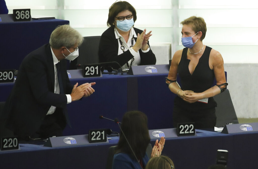 European Commissioner for Economy Paolo Gentiloni, left, speaks with Tokyo 2020 Paralympic gold medallist Beatrice Vio, right, at the European Parliament in Strasbourg, France, Wednesday, Sept. 15, 2021. The European Union announced Wednesday it is committing 200 million more coronavirus vaccine doses to Africa to help curb the COVID-19 pandemic on a global scale. (Yves Herman, Pool via AP)