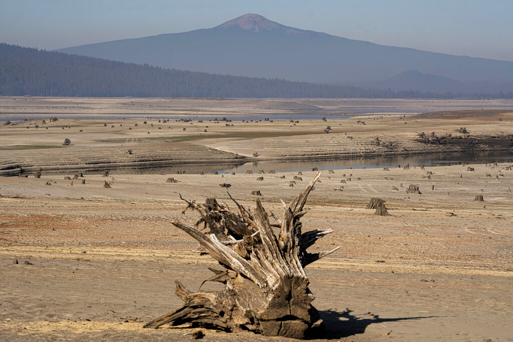 The dry lake bed of the Wickiup Reservoir is exposed by drought conditions that left the reservoir at 1 percent capacity on Wednesday, Sept. 1, 2021, near La Pine, Ore. As catastrophic drought ravages the West, the irrigation districts with water claims dating back more than a century are first in line for scarce water while others just up the road with more recent claims have already run out. (AP Photo/Nathan Howard)