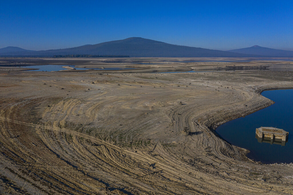 The lake bed of the Wickiup Reservoir is exposed by drought conditions that left the reservoir at 1% capacity on Wednesday, Sept. 1, 2021, near La Pine, Ore. (AP Photo/Nathan Howard)
