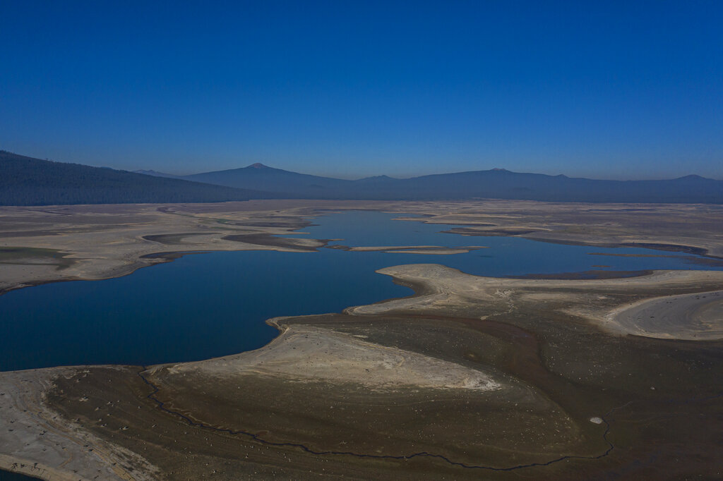 The lake bed of the Wickiup Reservoir is exposed by drought conditions that left the reservoir at 1% capacity on Wednesday, Sept. 1, 2021, near La Pine, Ore. (AP Photo/Nathan Howard)