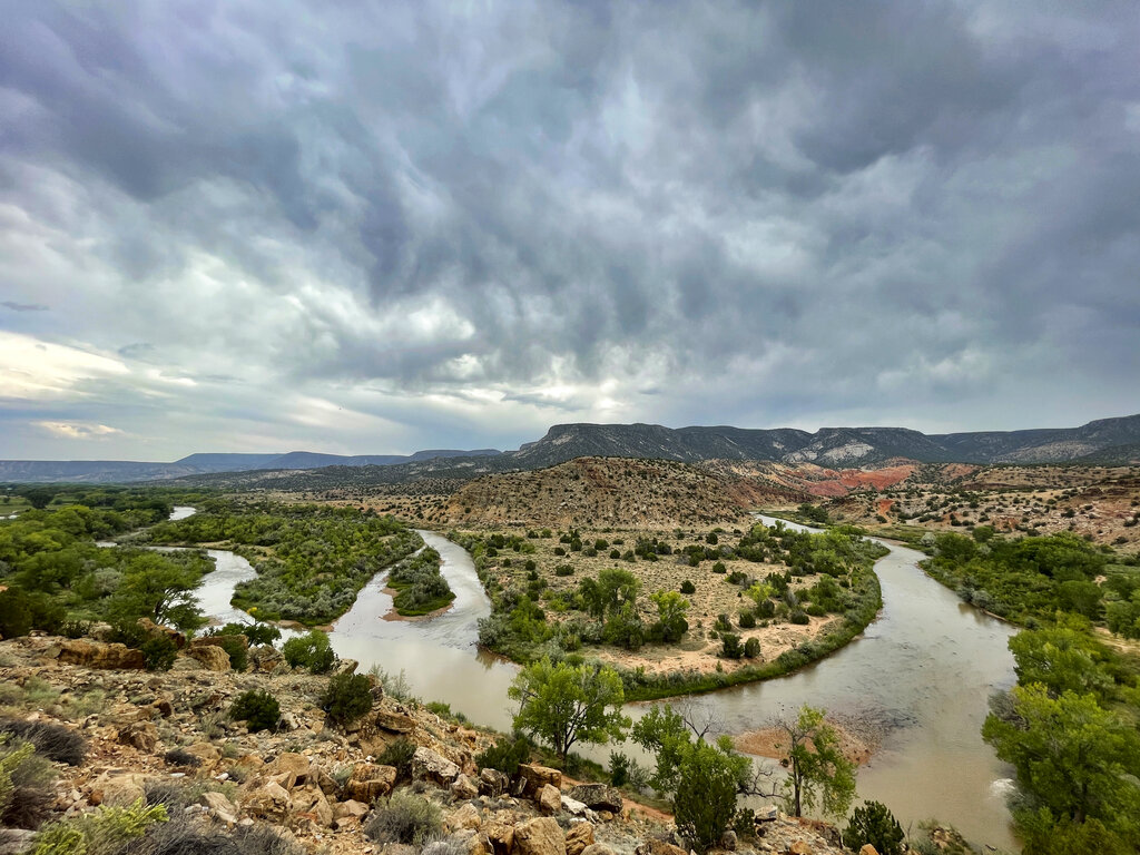 This Aug. 31, 2021 photo shows a bend in the Rio Chama near Abiquiu, New Mexico. Traditional irrigation systems known as acequias that depend on the river are feeling more pressure as drought persists and climate change piles on with warmer temperatures. (AP Photo/Susan Montoya Bryan)
