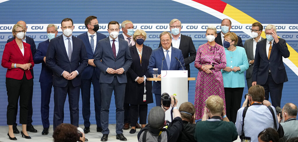 Governor Armin Laschet, center, the top CDU candidate stands between the party board members after the German parliament elections at the Christian Democratic Union, CDU, party's headquarters in Berlin, Sunday, Sept. 26, 2021. German voters have choosing a new parliament in an election that will determine who succeeds Chancellor Angela Merkel after her 16 years at the helm of Europe's biggest economy. (AP Photo/Martin Meissner)