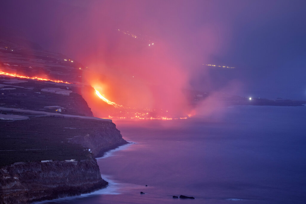 Lava from a volcano reaches the sea on the Canary island of La Palma, Spain, Wednesday Sept. 29, 2021. Lava from a volcano that erupted Sept. 19 on Spain's Canary Islands has finally reached the Atlantic Ocean after wiping out hundreds of homes and forcing the evacuation of thousands of residents. (AP Photo/Saul Santos)