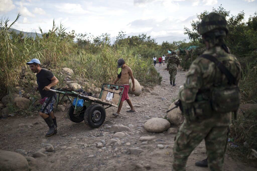 Venezuelans cross illegally into Colombia from Venezuela, near the Simon Bolivar International Bridge in La Parada near Cucuta, Colombia, Tuesday, Oct. 5, 2021. Venezuela partially reopened its border with Colombia after closing it on 2019, a nearly three-year closure due to political tensions. (AP Photo/Ivan Valencia)