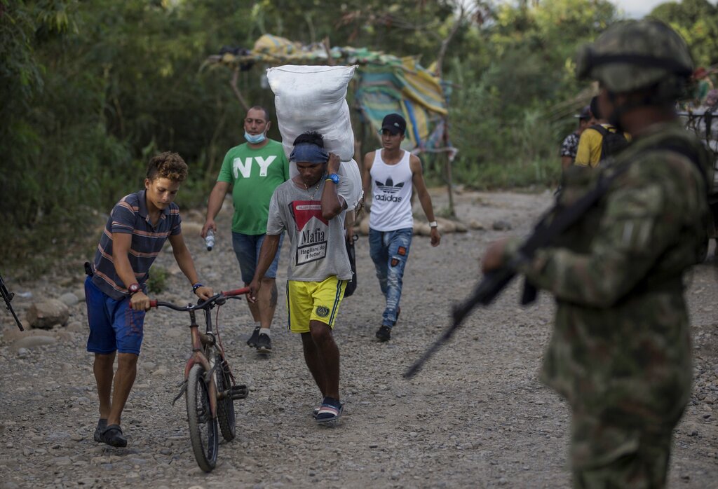 Venezuelans cross illegally into Colombia from Venezuela, near the Simon Bolivar International Bridge in La Parada near Cucuta, Colombia, Tuesday, Oct. 5, 2021. Venezuela partially reopened its border with Colombia after closing it on 2019, a nearly three-year closure due to political tensions. (AP Photo/Ivan Valencia)