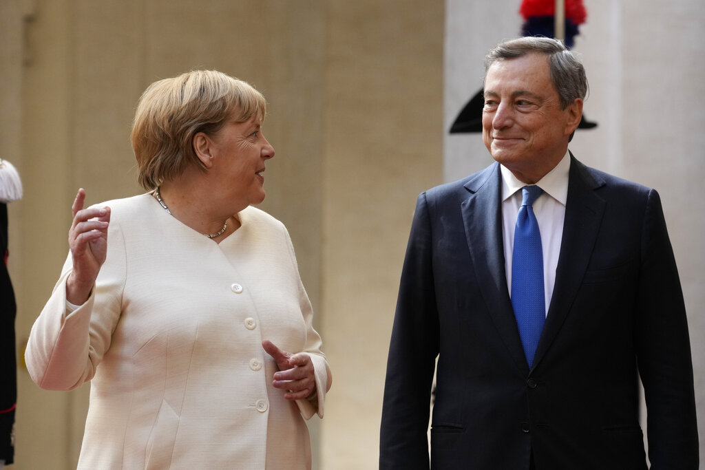 Italian Premier Mario Draghi, right, welcomes German Chancellor Angela Merkel as she arrives at Palazzo Chigi Premier office, in Rome, Thursday, Oct. 7, 2021. (AP Photo/Andrew Medichini)