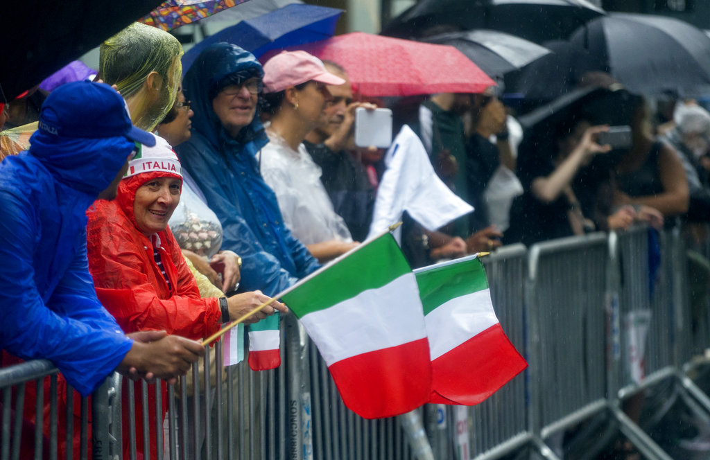 Spectators brave the rain along 5th Ave. during the annual Columbus Day Parade in New York Monday, Oct 9, 2017. (AP Photo/Craig Ruttle)