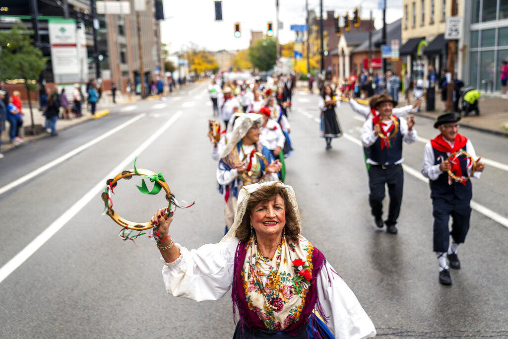 Members of the Spigno Saturnia Society dance in the Pittsburgh Columbus Day Parade on Liberty Avenue in Pittsburgh, Saturday, Oct. 9, 2021. (Alexandra Wimley/Pittsburgh Post-Gazette via AP)