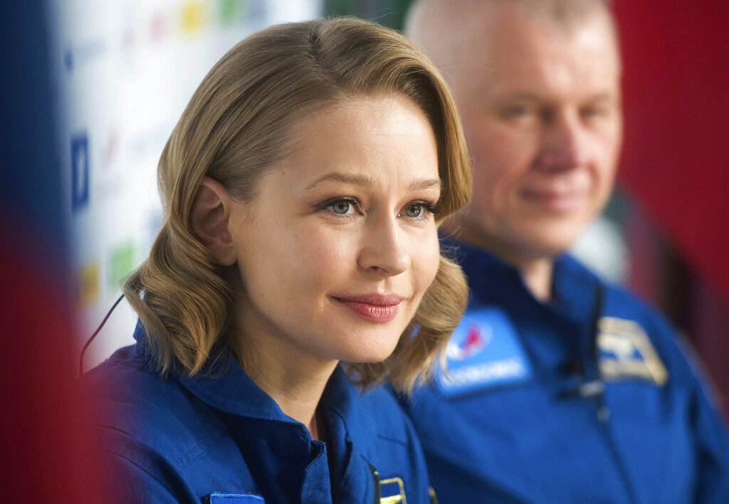 In this photo released by the Roscosmos Space Agency, actress Yulia Peresild attends a news conference in Moscow, Russia, Tuesday, Oct. 19, 2021. Actress Yulia Peresild and director Klim Shipenko flew to the International Space Station in a Russian Soyuz spacecraft together with cosmonaut Anton Shkaplerov and spent 12 days in orbit making the world's first movie in space. After a stint on the station, they returned to Earth on Sunday with another veteran Russian cosmonaut, Oleg Novitskiy. (Roscosmos Space Agency via AP)