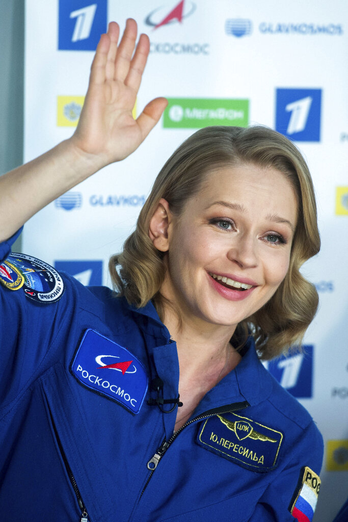 In this photo released by the Roscosmos Space Agency, actress Yulia Peresild gestures during a news conference in Moscow, Russia, Tuesday, Oct. 19, 2021. Actress Yulia Peresild and director Klim Shipenko flew to the International Space Station in a Russian Soyuz spacecraft together with cosmonaut Anton Shkaplerov and spent 12 days in orbit making the world's first movie in space. After a stint on the station, they returned to Earth on Sunday with another veteran Russian cosmonaut, Oleg Novitskiy. (Roscosmos Space Agency via AP)