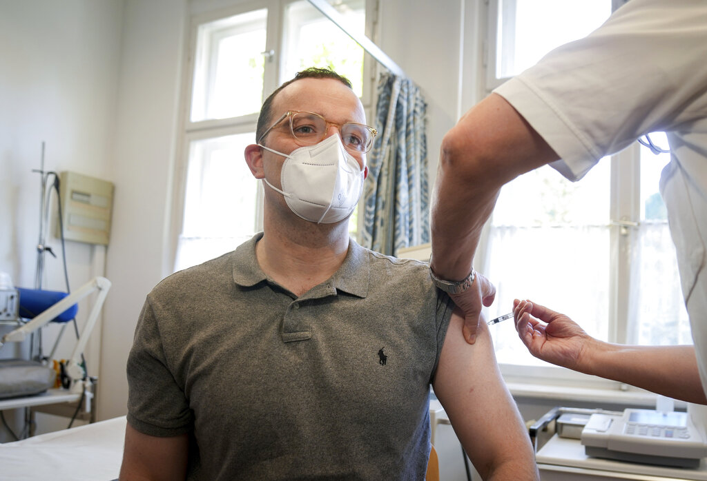 German Health Minister Jens Spahn is vaccinated against influenza in a doctor's office in Berlin, Germany, Wednesday, Oct. 6, 2021.  Spahn urged people to get vaccinated against flu this year, to avoid a surge in hospitalizations amid the ongoing coronavirus pandemic. (Kay Nietfeld/dpa via AP)