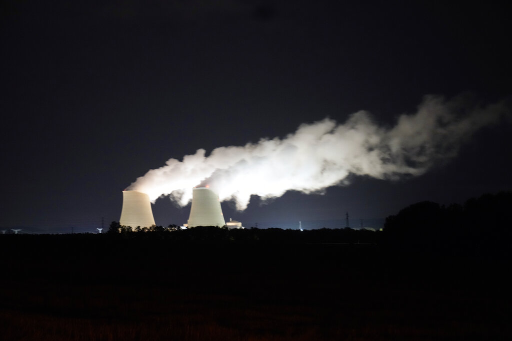 FILE - Steam escapes at night from the nuclear plant of Nogent-sur-Seine, 110 kms (63 miles) south east of Paris, Sunday, Aug. 8, 2021. Nuclear power is a central sticking point as negotiators plot out the world’s future energy strategy at the Glasgow climate talks. Critics decry its mammoth price tag, the accident risk and deadly waste. But a growing pro-nuclear camp argues that it’s safer on average than nearly any other energy source.  (AP Photo/Francois Mori, File)