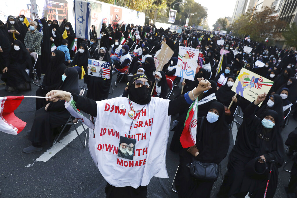 Demonstrators chant slogans in a rally in front of the former U.S. Embassy commemorating the anniversary of its 1979 seizure in Tehran, Iran, Thursday, Nov. 4, 2021. The embassy takeover triggered a 444-day hostage crisis and break in diplomatic relations that continues to this day. (AP Photo/Vahid Salemi)