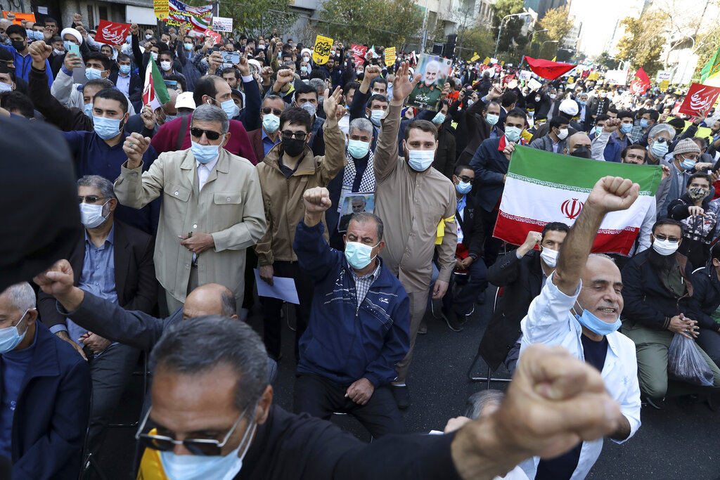 Demonstrators chant slogans during a rally in front of the former U.S. Embassy commemorating the anniversary of its 1979 seizure in Tehran, Iran, Thursday, Nov. 4, 2021. The embassy takeover triggered a 444-day hostage crisis and break in diplomatic relations that continues to this day. (AP Photo/Vahid Salemi)