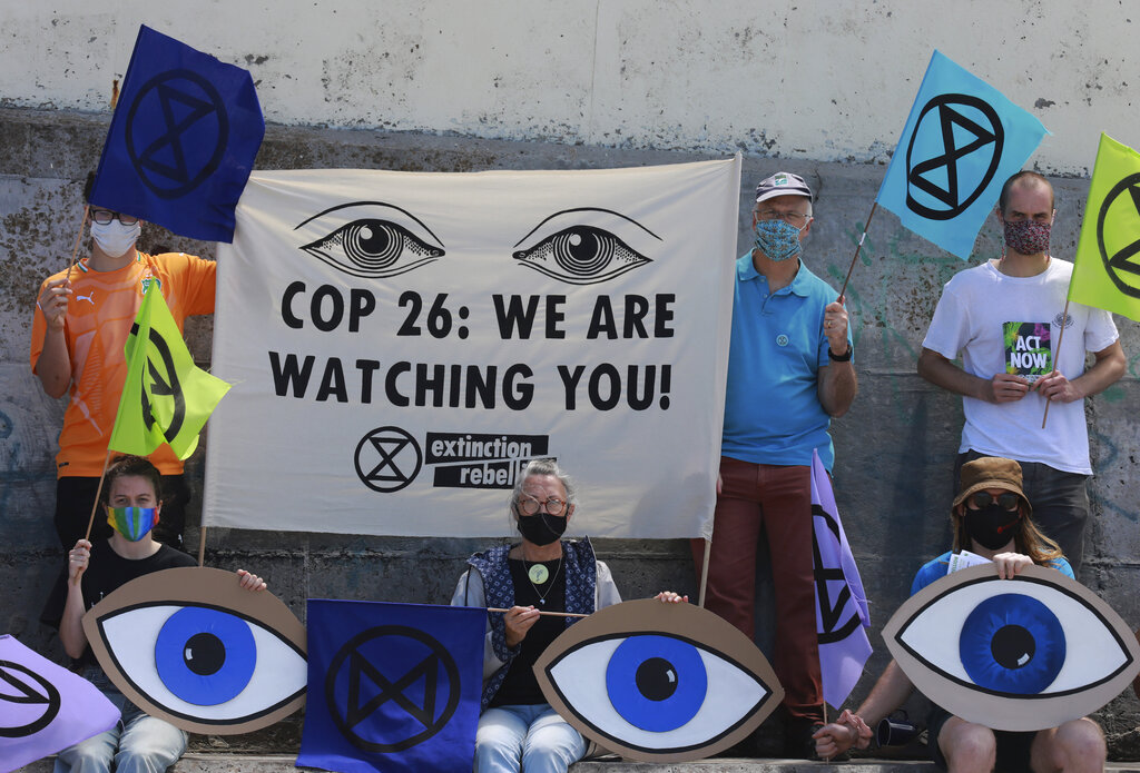 Extinction Rebellion activists protest on Muizenberg Beach in Cape Town, South Africa, Saturday, Nov. 6, 2021.Many people across the world are taking part in protests as the first week of the COP26, UN Climate Summit in Glasgow comes to an end. (AP Photo/Nardus Engelbrecht)